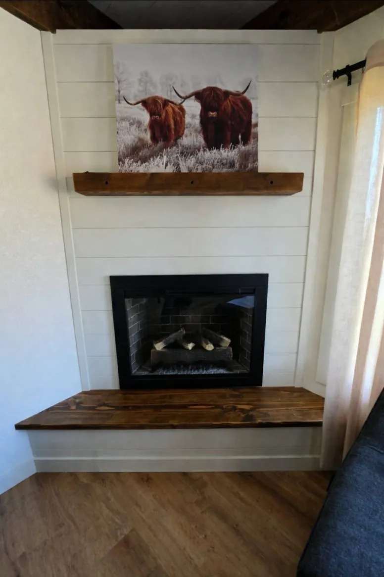 Shiplap fireplace surround with reclaimed wood mantel and hearth bench