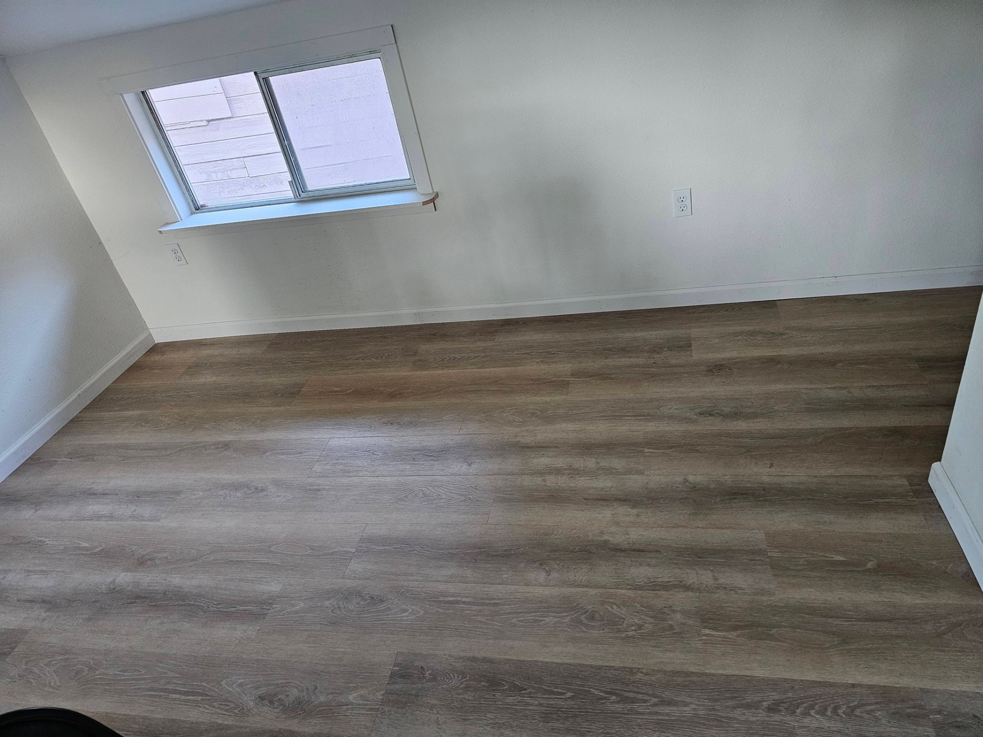 Bedroom with new wide-plank vinyl flooring and fresh paint