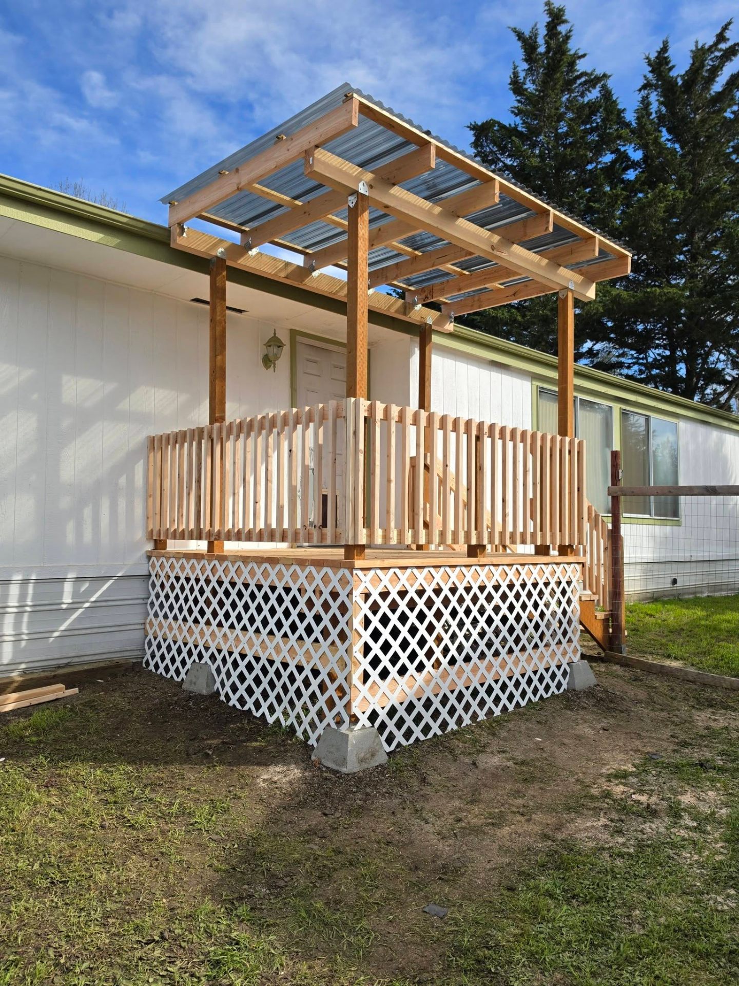 New cedar entry deck with covered metal roof and lattice skirting